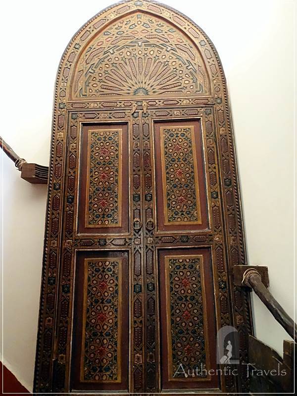 Dar Kamal Chaoui: a decorative old door with book shelves behind it