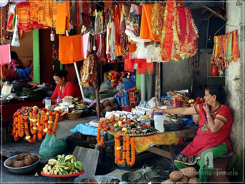 Budhanilkantha (a suburb of Kathmandu): women selling orange flowers for offerings at the temple