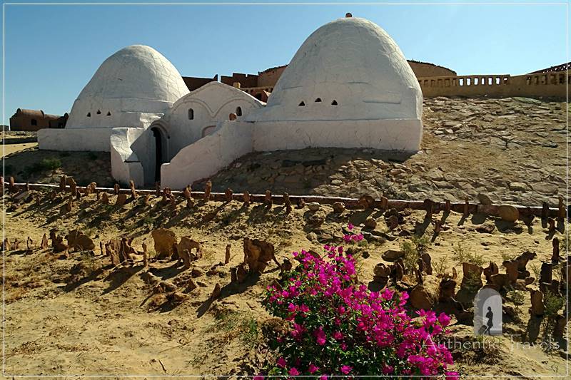 Two white domed cottages 